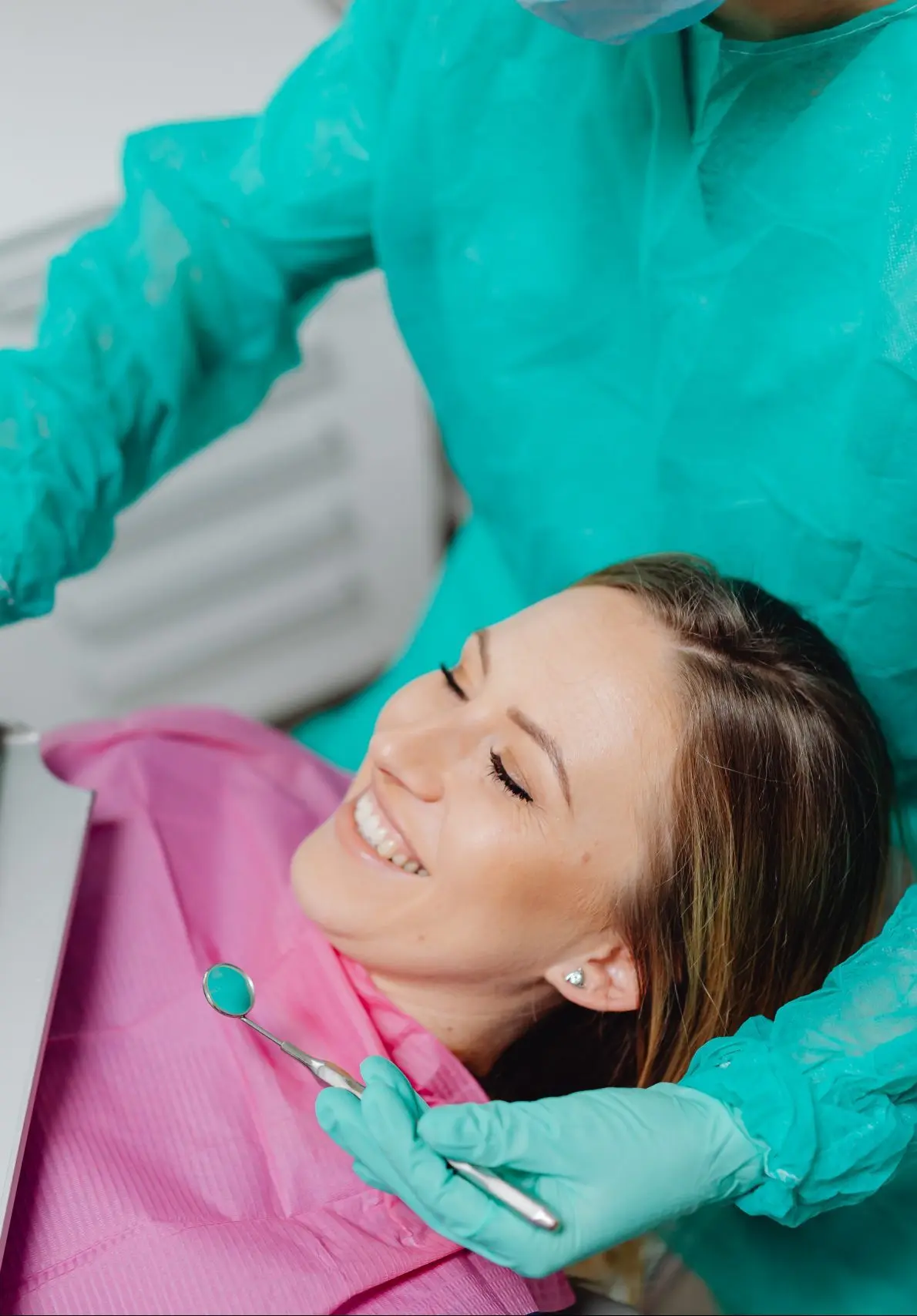 A patient smiling with the dental team at Valley Dental Turlock