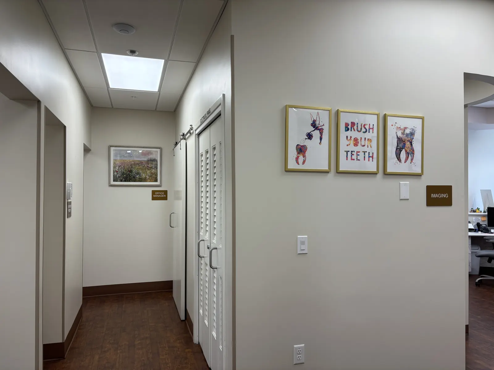 A bright hallway with playful dental artwork inside Valley Dental Turlock