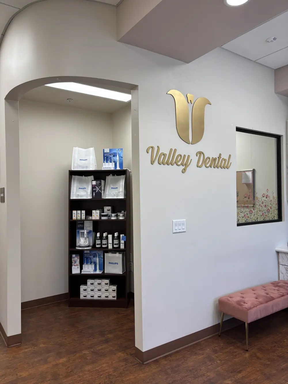 The Valley Dental logo wall and dental care product display in our Turlock office